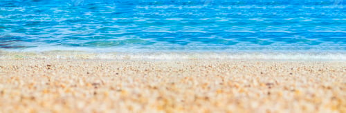 Preview: summer beach low angle view background.Close up wave of blue sea on sand beach seashore