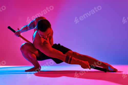 Preview: Animal instinct fitness instructor sportsman showing his incredible flexibility with an animal flow