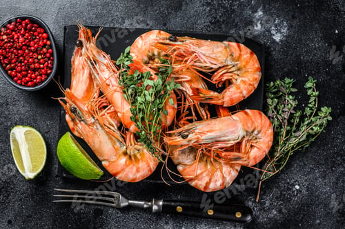 Preview: Red Langostino shrimps Prawns on a marble board. Black background. Top view