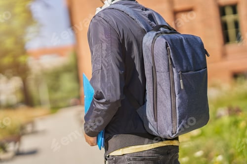 Preview: Back midsection of male student in the campus