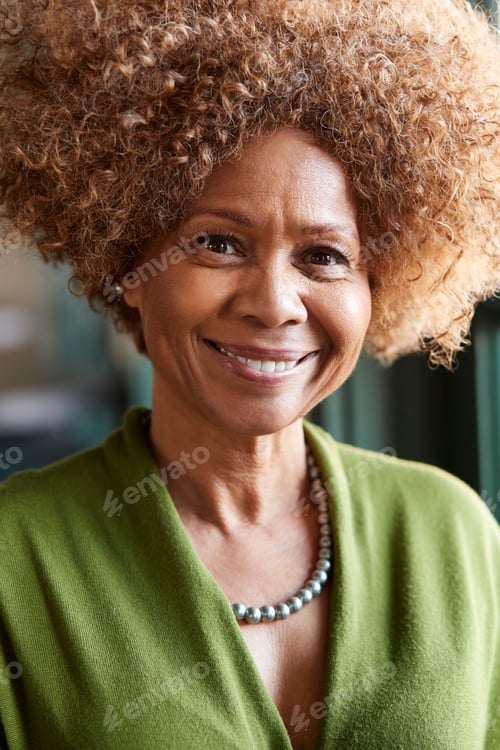 Preview: Portrait Of Smiling Senior Woman Sitting In Restaurant