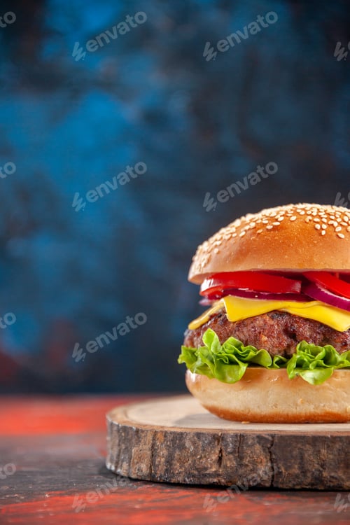 Preview: front view tasty cheeseburger with meat tomatoes and green salad on dark blue background sandwich