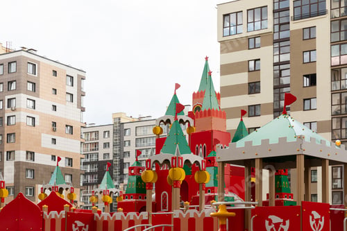 Preview: Bright colourful playground for children at apartment background in dormitory district