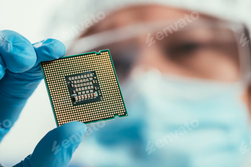 Preview: selective focus of engineer holding computer microchip