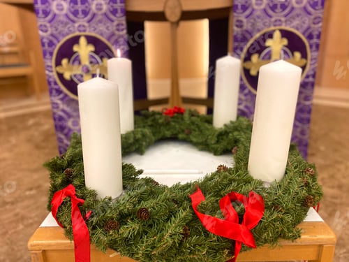 Preview: Christmas Advent wreath in a church setting with candle of Hope lighted