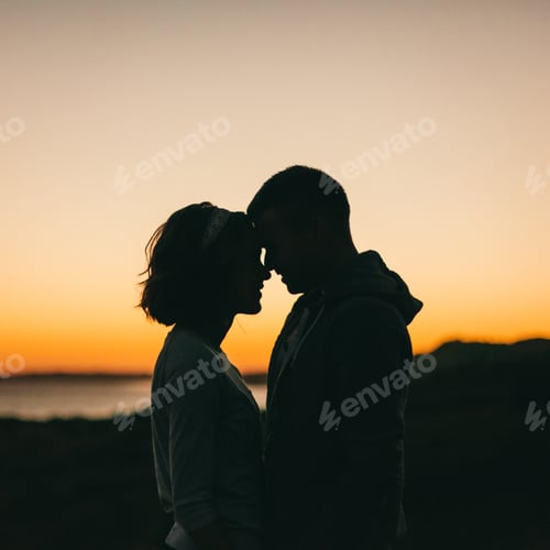 Preview: Silhouetted Couple Embrace at Sunset Overlooking the Water