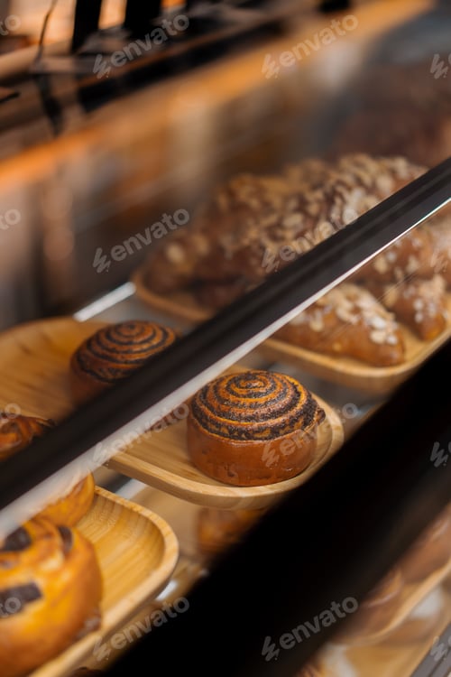 Preview: Counter full of delicious buns and pastries in shop, bakery