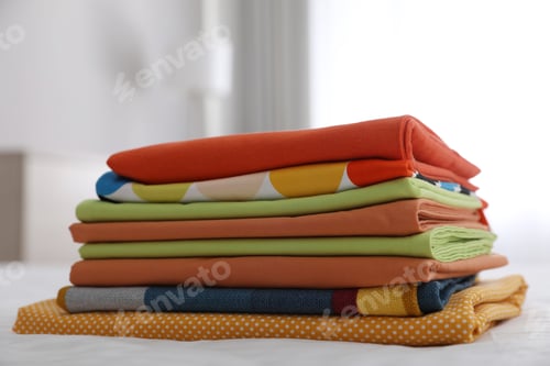 Preview: Clean color folded linens on bed indoors