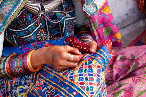 Preview: Tribal woman working her traditional handicrafts by embroidering colorful thread., india