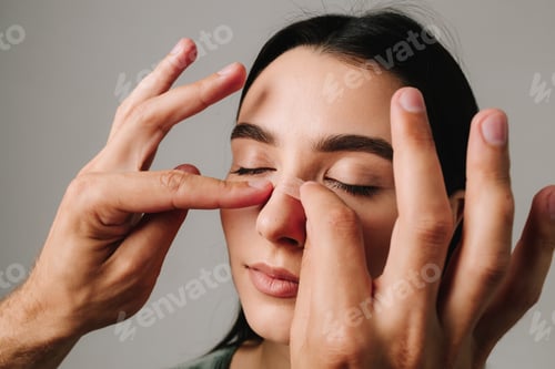Preview: Plastic surgeon securing nose after rhinoplasty to support reshaped structure