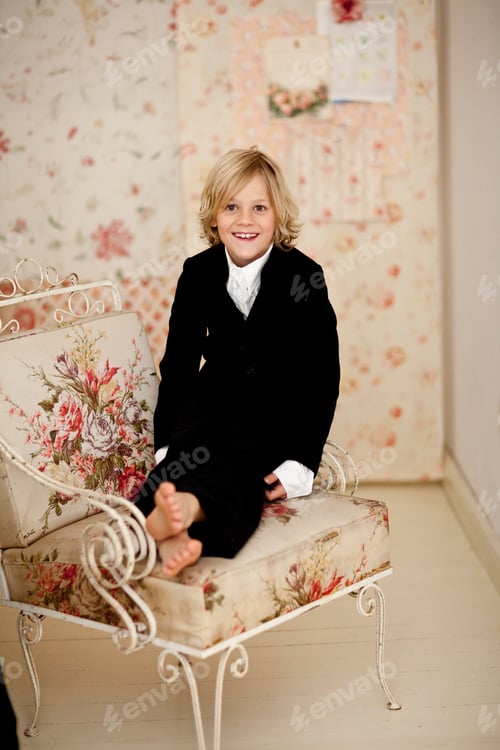 Preview: Smiling boy sitting in armchair