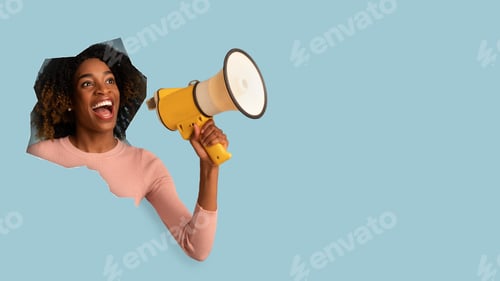 Preview: Happy excited funny millennial african american woman with open mouth, shouts in megafon