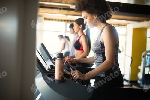 Preview: Group of young people training in gym