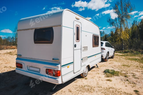 Preview: White trailer caravan car is parked on the side of the road. Ready to vacation.