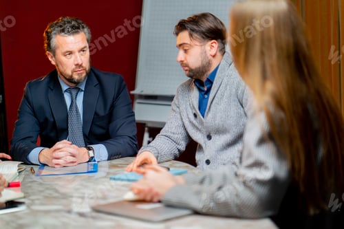 Preview: conference room red walls office workers are sitting at the head of the director discussing business