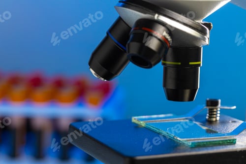 Preview: Close up photo of a microscope lenses examining glass sample