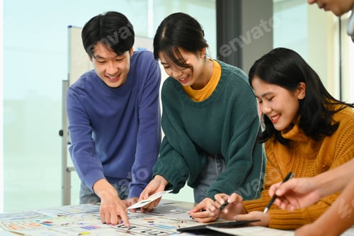 Preview: Group of application developers working on new website wireframe at creative office.