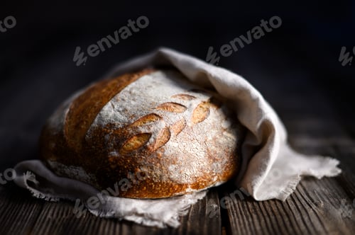Preview: Close up of crusty leavened sourdough bread with a rough browned skin