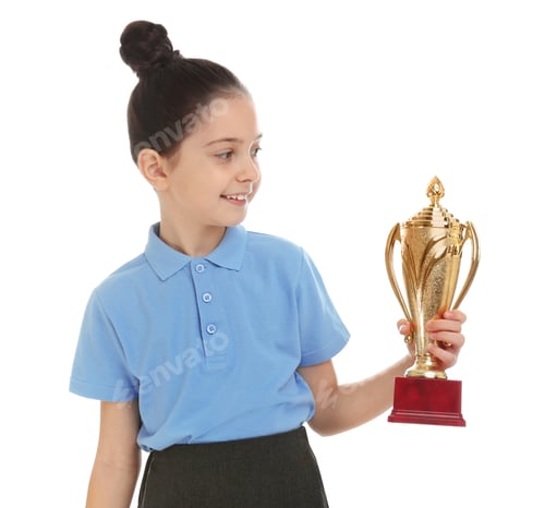 Preview: Happy girl in school uniform with golden winning cup isolated on white