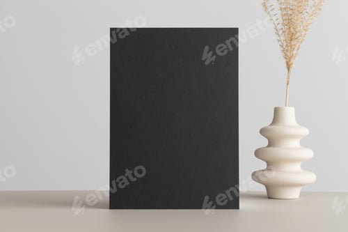 Preview: Black invitation card mockup with a flower on the beige table. 5x7 ratio, similar to A6, A5.