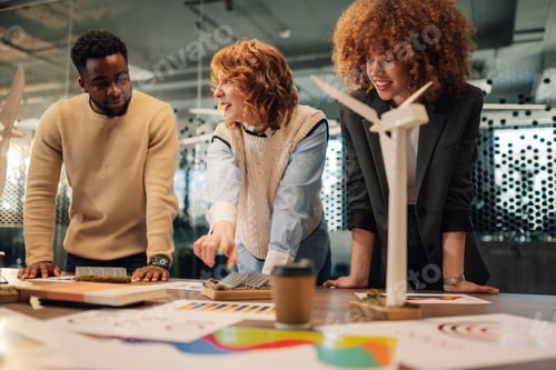 Preview: Interracial office staff doing research for renewable energy at office.