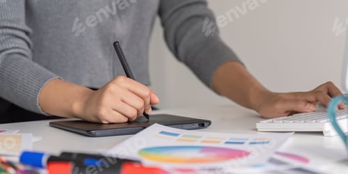 Preview: Creative Graphic Designer Working on Digital Tablet and Computer with Color Swatches and Markers on