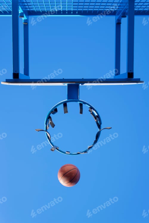 Preview: Image of a ball beside a basketball hoop,