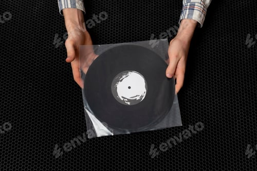 Preview: a top view of music lover holding vinyl music record
