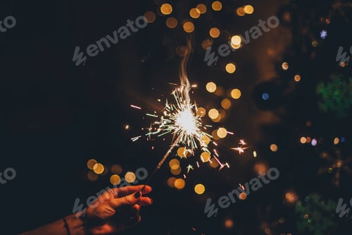 Preview: Sparkler in hand and lights bokeh