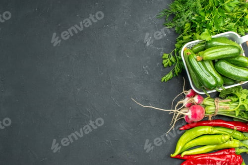 Preview: top view fresh green cucumbers with greens and vegetables on dark background color food health photo