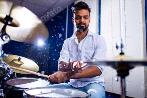 Preview: indian man playing the drums sticks close-up in recording studio