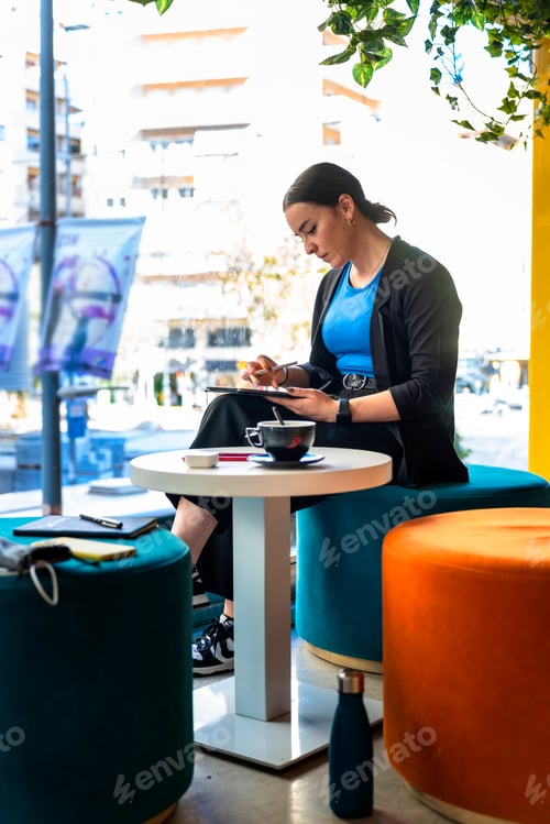 Preview: Middle aged business woman taking notes on a tablet
