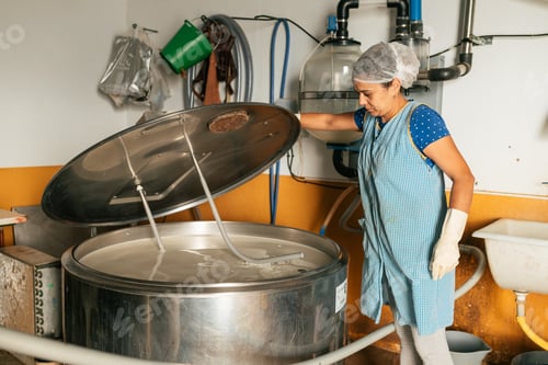 Preview: Professional female worker checking metal machine