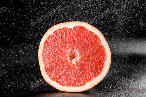 Preview: Grapefruit with water drops on black background. Citrus fruit. Healthy freshness food.
