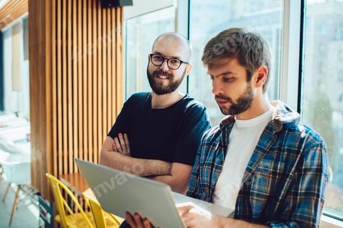 Preview: Concentrated coworkers browsing netbook in office