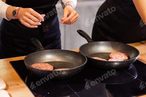 Preview: Meat burgers or cutlet-shaped patty being roasting in oil on a frying pan