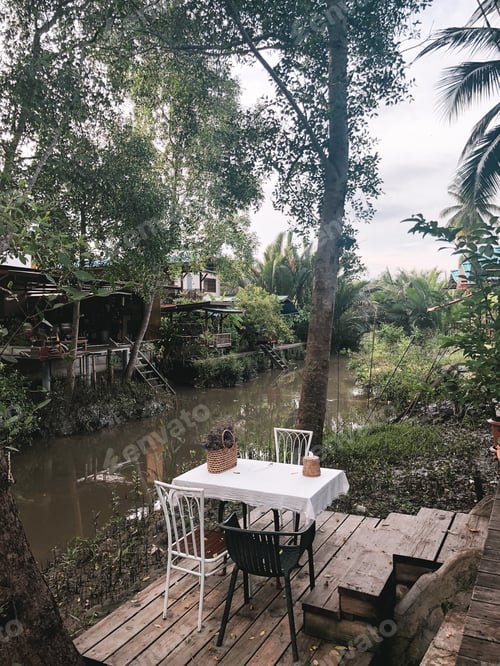 Preview: Cafe tables and chairs outside with local tropical background