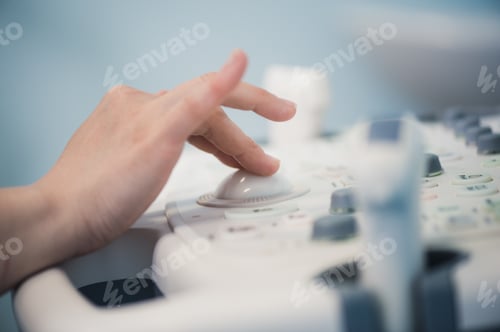 Preview: young woman doctor's hands close up preparing for an ultrasound device scan.
