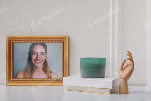 Preview: Photo frame with portrait of beautiful young woman near stylish decor on white table
