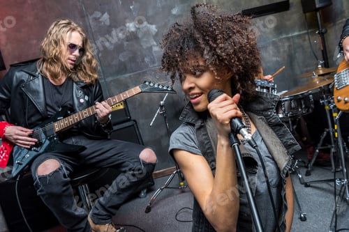 Preview: young rock band rehearsing in musical studio, hard rock music concept