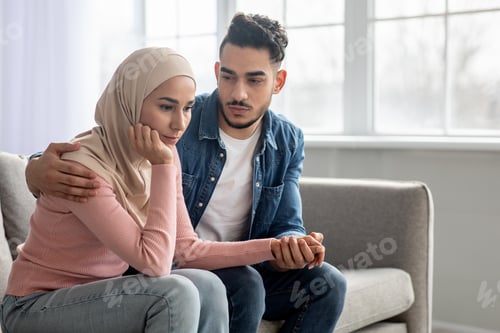 Preview: Loving middle-eastern man comforting his depressed wife, home interior