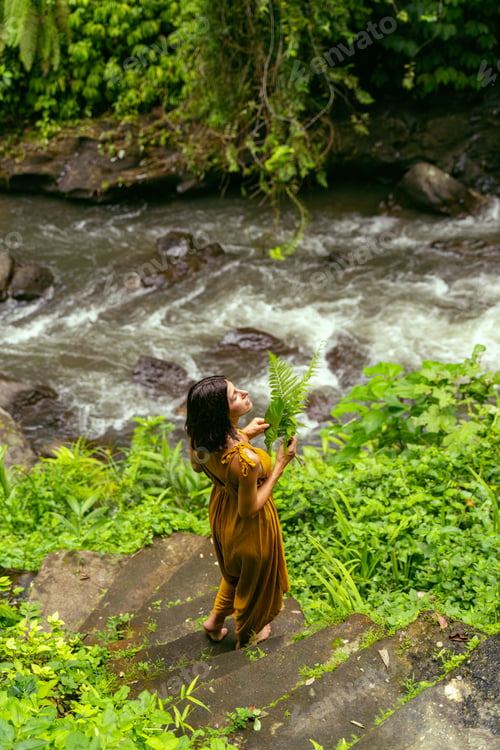 Preview: Relaxed brunette girl listening to sounds of river