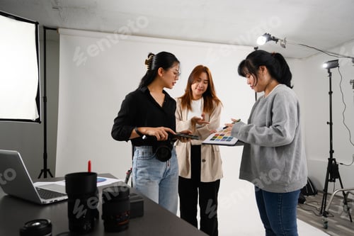 Preview: Team of photographers working together in modern lighting studio