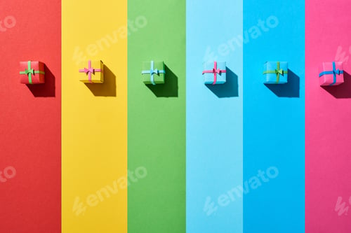 Preview: top view of multicolored gift boxes on rainbow background