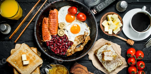 Preview: Traditional English Breakfast with fried eggs, sausages and aromatic coffee.