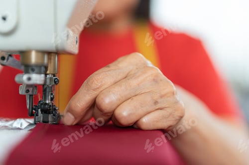 Preview: Hands of a woman sewing in a workshop