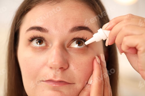 Preview: Woman applying eye drops on blurred background, closeup