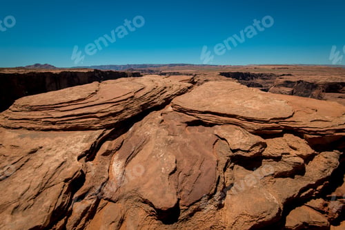 Preview: Grand Canyon brown stones, horizon and blue sky during the hot summer day