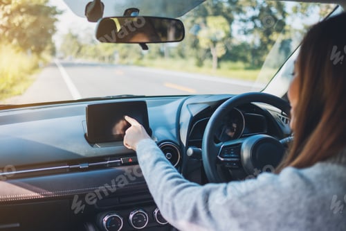 Preview: Closeup image a beautiful woman using and pointing finger at navigation screen while driving car
