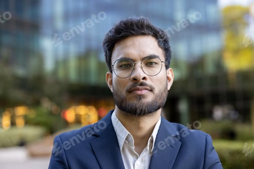 Preview: Confident business professional standing outdoors in formal attire near modern office building